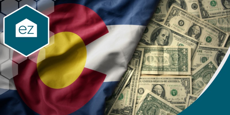Colorado Flag beside a bunch of dollar bills
