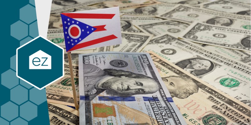 Ohio flag with dollar bills in the background