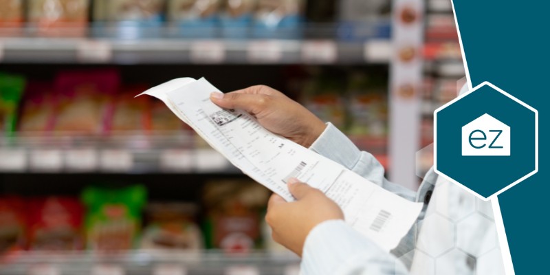 a person holding a receipt in a grocery store