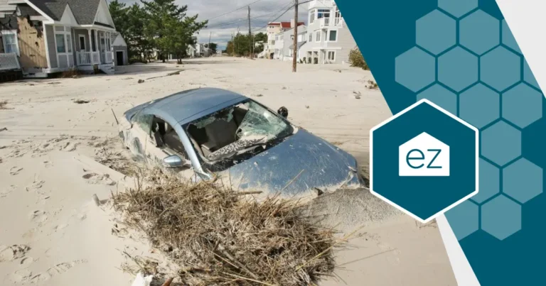 a car almost burried during coastal erosion