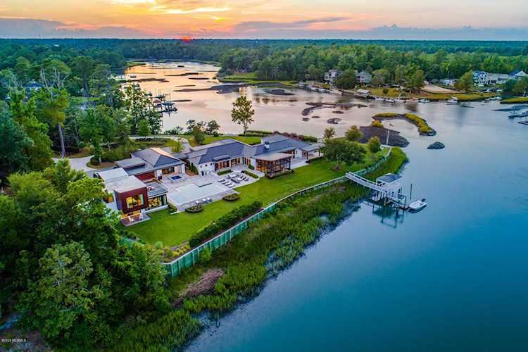 Aerial View of a Luxury Home on Creek with Sunset in Background