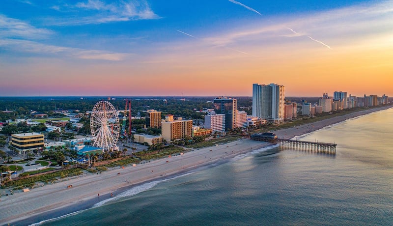 Myrtle Beach, South Carolina skyline and ferris wheel at sunset by the ocean