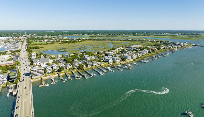 Homes on the waterway as boats goes by in Wrightsville Beach, North Carolina